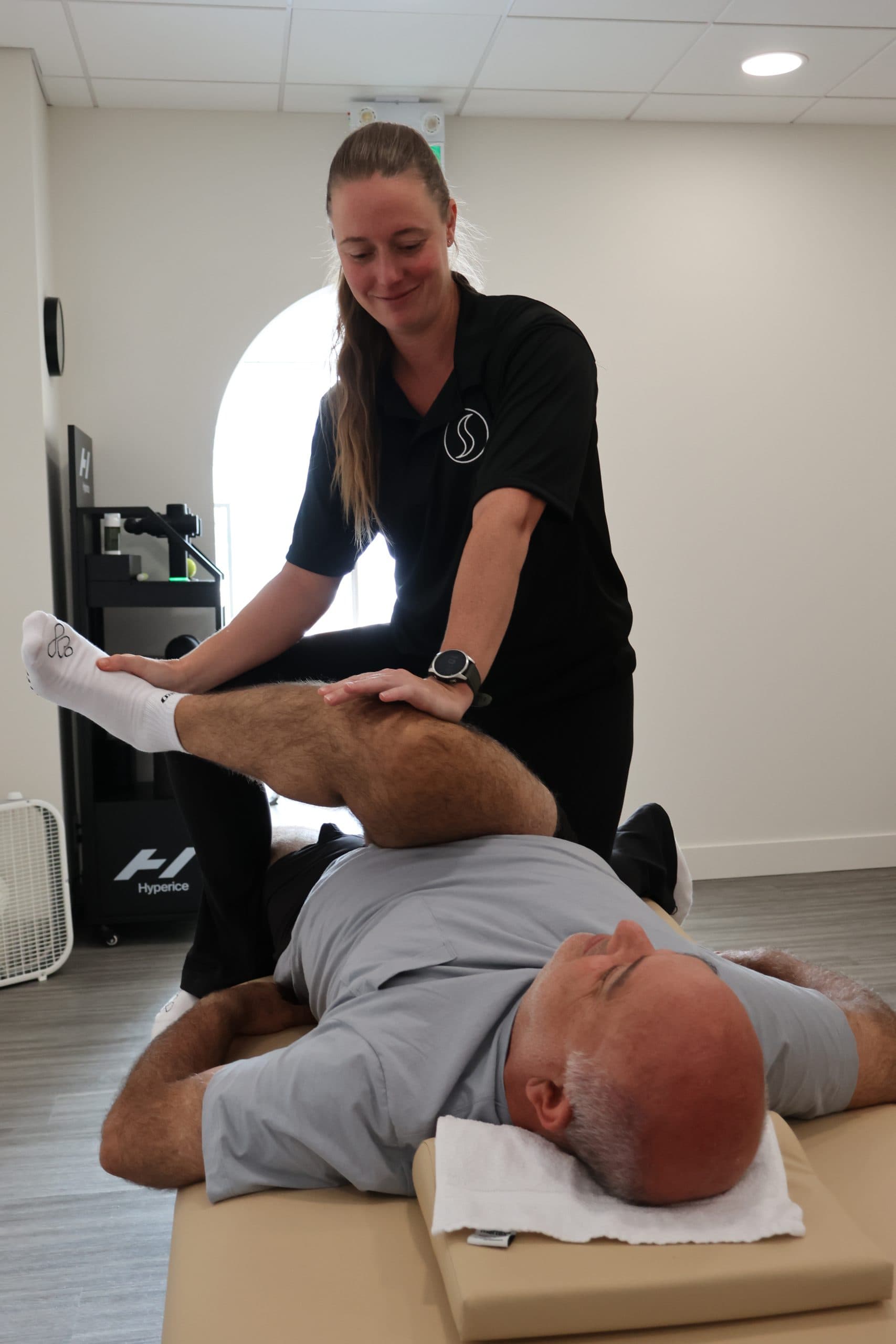 A practitioner working with a client at StretchWell